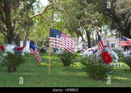 Memorial Day flags placed at the grave sites to pay tribute to fallen servicemen and women who gave their lives in service to our country Stock Photo