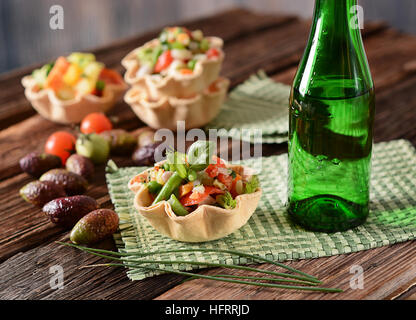 salad of assorted vegetables in the basket of bread Stock Photo