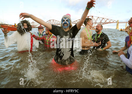 Swimmers take part in the Loony Dook New Year's Day dip in the Firth of Forth at South Queensferry, as part of Edinburgh's Hogmanay celebrations. Stock Photo