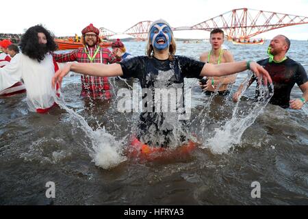 Swimmers take part in the Loony Dook New Year's Day dip in the Firth of Forth at South Queensferry, as part of Edinburgh's Hogmanay celebrations. Stock Photo