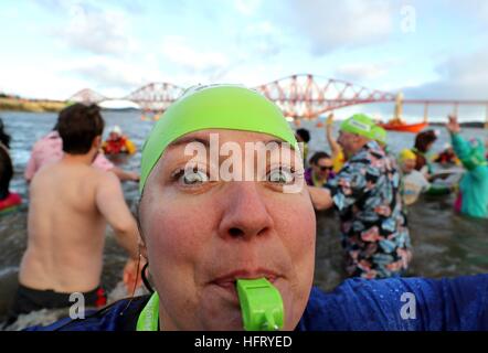 Swimmers take part in the Loony Dook New Year's Day dip in the Firth of Forth at South Queensferry, as part of Edinburgh's Hogmanay celebrations. Stock Photo