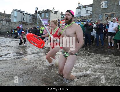 Swimmers take part in the Loony Dook New Year's Day dip in the Firth of Forth at South Queensferry, as part of Edinburgh's Hogmanay celebrations. Stock Photo