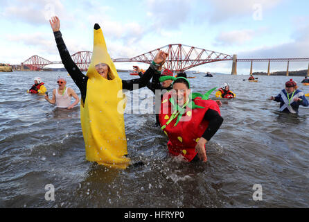 Swimmers take part in the Loony Dook New Year's Day dip in the Firth of Forth at South Queensferry, as part of Edinburgh's Hogmanay celebrations. Stock Photo