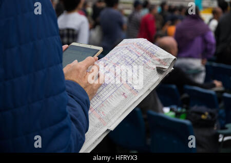 Hong Kong, Hong Kong. 01st Jan, 2017. Racegoers prepared detailed handwritten notes and used web-based applications to place their bets. 100,000 racing fans can't wait to try their luck at Hong Kong Jockey Club's 'Lucky Star January 1 Race Day' in Shatin Racecourse. 1st January 2017 © Alda Tsang/Pacific Press/Alamy Live News Stock Photo