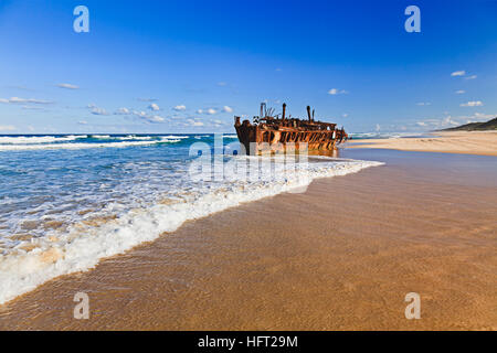 Historis SS Maheno shipwreck on Fraser Island sandy beach rusting down on a sunny summer day. Stock Photo