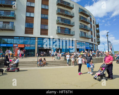 Tourists holiday makers The Sands North Bay Scarborough North Yorkshire Coast UK Stock Photo