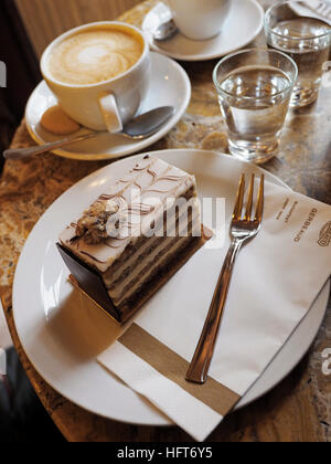 Esterhazy torte cake and cappuccino at Gerbeaud kavehaz in Budapest, Hungary. Stock Photo