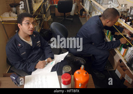 061025-N-1332Y-174 Pacific Ocean (Oct. 25, 2006) - Storekeeper 3rd Class Freddy Cruz from New York City, and Aviation Support Equipment Technician 3rd Class Daniel Brown from Los Angeles, complete a customer's paint order inside USS Kitty Hawk (CV 63) hazardous material (HAZMAT) trailer. Kitty Hawk's HAZMAT personnel are responsible for issuing, storing and inventorying all hazardous material aboard the ship. Kitty Hawk, operating out of Fleet Activities Yokosuka, Japan, is currently deployed off the coast of southern Japan on a regularly scheduled deployment. U.S. Navy photo by Mass Communica Stock Photo