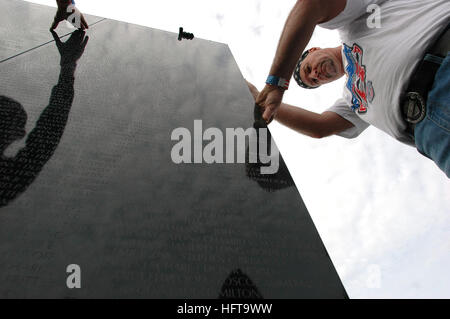 061115-N-4515N-404 Virginia Beach, Va. (Nov. 15, 2006) - Tim Spratley from Chesapeake, Va. helped Seabees assigned to Construction Battalion Maintenance Unit Two Zero Two (CBMU-202), build the foundation for the Dignity Memorial Vietnam Wall at Mt. Trashmore Park in Virginia Beach, Va. The exhibit crisscrosses the country each year, allowing millions of visitors to see and touch the black, mirror-like surface inscribed with the names of more than 58,000 Americans who died or are missing in Vietnam. The wall honors all U.S. veterans and is dedicated to Vietnam veterans. U.S. Navy photo by Mass  Stock Photo