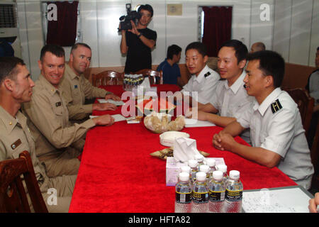 061119-N-4124C-005 South China Sea (Nov. 17, 2006) - Planning team leaders of the U.S.-China combined search and rescue exercise (SAREX) meet for a debrief aboard the Army (Navy) (PLA (N)) ship Zhnajiang (DD 165) after the exercise, all of them expressing sentiments of success. Amphibious transport dock USS Juneau (LPD 10) and guided-missile destroyer Fitzgerald (DDG 62) joined Zhanjiang for the SAREX, the second phase of a two-phase bilateral training agreement. The first SAREX was held off the coast of Southern California in September. U.S. Navy photo by Mass Communication Specialist 3rd Cla Stock Photo