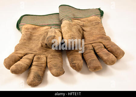 Pair of well used gloves isolated on white. Stock Photo