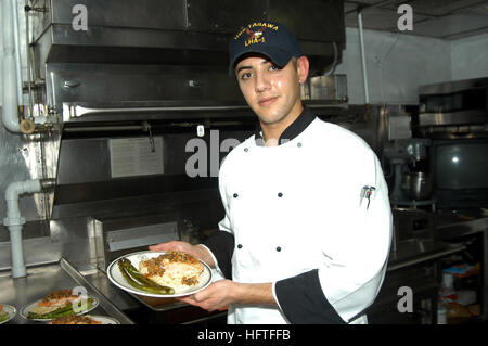 070213-N-7029R-021 San Diego (Feb. 13, 2007) - Culinary Specialist 3rd Class Joseph Chiarelli shows off a dish he prepared for the Emeril Live Show. Chiarelli will fly to New York with fellow military chefs to perform on the show. U.S. Navy photo by Mass Communication Specialist 2nd Class Alexia Riveracorrea  (REALEASED) US Navy 070213-N-7029R-021 Culinary Specialist 3rd Class Joseph Chiarelli shows off a dish he prepared for the Emeril Live Show Stock Photo