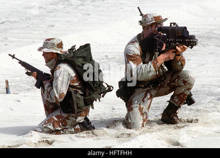 Two Sea-Air-Land (SEAL) team members, one equipped with an AN-PAQ-1 laser target designator, right, the other armed with an M-14 rifle, assume a defensive position after assaulting the beach during an amphibious demonstration for the 14th Annual Inter-American Naval Conference. US Navy SEALs with laser designator closeup Stock Photo