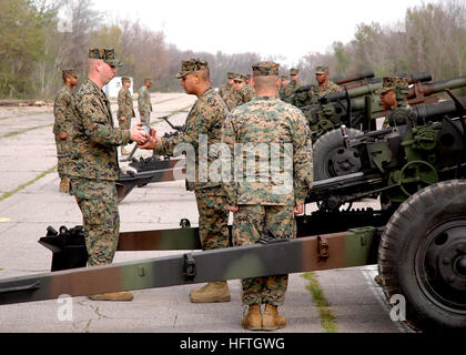 070307-N-9274T-003 BELLE CHASSE, La. (March 7, 2007) - Staff Sgt. Robert Reynolds, Sgt. Harold Subia, and Sgt. Christopher Sepeda prepare to load a WWII era howitzer at the Naval Air Station Joint Reserve Base New Orleans old airfield. The base provided the practice area to the Marines from the 14th Marine Regiment so they could prepare for the March 10th commissioning of the USS New Orleans (LPD-18.) U.S. Navy photo by Mass Communication Specialist 2nd Class William Townsend (RELEASED) US Navy 070307-N-9274T-003 Staff Sgt. Robert Reynolds, Sgt. Harold Subia, and Sgt. Christopher Sepeda prepar Stock Photo
