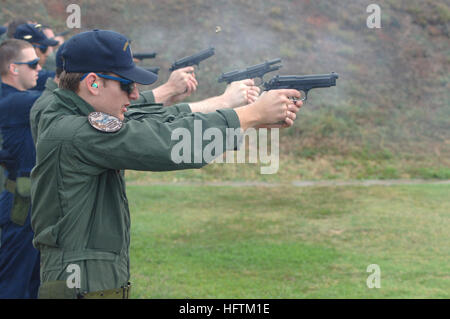 070414-N-3398B-020 KANEOHE BAY, Hawaii (April 14, 2007) - Aviation Warfare Systems Operator 3rd Class Michael Odell of Patrol Squadron (VP) 47 discharges his weapon during a 9mm pistol qualification aboard Marine Corps Base Hawaii gun range. The 9mm pistol qualification is a requirement of all personnel assigned to VP-47 as part of their Interdeploymnet Readiness Cycle, which prepares them for deployment overseas. U.S. Navy photo by Mass Communication Specialist 3rd Class Kevin S. Beauchamp  (RELEASED) US Navy 070414-N-3398B-020 Aviation Warfare Systems Operator 3rd Class Michael Odell of Patr Stock Photo