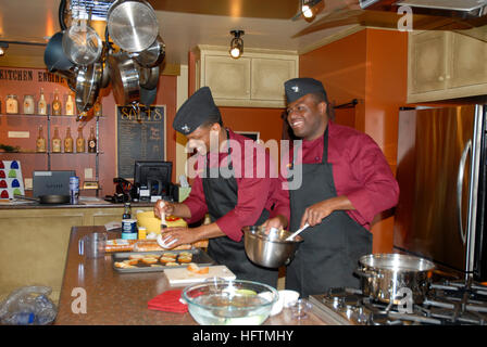 100513-N-0869H-013 SPOKANE, Wash. (May 13, 2010) Culinary Specialist 2nd Class Demontray Braswell, left, and Personnel Specialist 3rd Class Wendall Nelson, both assigned to Navy Operational Support Center Spokane, prepare tomato brochette samples for patrons of Kitchen Engine, a local cooking products shop. The Sailors are participating in events for Spokane Navy Week. Spokane Navy Week is one of 20 Navy Weeks planned across America for 2010. Navy Weeks show Americans the investment they have made in their Navy and increase awareness in cities that do not have a significant Navy presence. (U.S Stock Photo