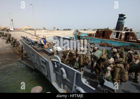 070420-N-9818V-153 CAMP PATRIOT, Kuwait (April 20, 2007) - Marines attached to the 26th Marine Expeditionary Unit out of Camp Lejeune, N.C., disembark a landing craft utility assigned to Assault Craft Unit (ACU) 2 for an offload of troops and equipment from the USS Bataan (LHD 5). Bataan Expeditionary Strike Group is underway in the Persian Gulf conducting maritime security operations. U.S. Navy photo by Mass Communication Specialist 2nd Class Jennifer A. Villalovos (RELEASED) US Navy 070420-N-9818V-153 Marines attached to the 26th Marine Expeditionary Unit out of Camp Lejeune, N.C., disembark Stock Photo