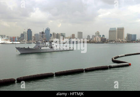 The port side bow view of the US Navy (USN) Arleigh Burke Class Guided Missile Destroyer, USS MCCAMPBELL (DDG 85) as it is underway departing its homeport of San Diego, California (CA). The San Diego skyline is seen in the background. USS McCampbell (DDG-85) Stock Photo