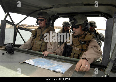 070427-N-4928M-038 HADITHA DAM, Iraq (April 27, 2007) - Engineman 1st Class Stacy Burleson, left, and Quartermaster 1st Class Michael Beane from the NavyÕs Riverine Squadron (RIVRON) 1, conduct an orientation ride in a Small Unit Riverine Craft (SURC) at Lake Qadisiya, the man-made reservoir on the North side of Haditha Dam. RIVRON 1, based out of Naval Amphibious Base (NAB) Little Creek, is currently supporting the 2nd Marine Expeditionary Force (II MEF) in the Al Anbar province of Iraq. The deployment marks the first for a Navy riverine squadron since the Vietnam War. U.S. Navy photo by Seni Stock Photo