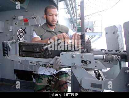 070531-N-9640S-018 PERSIAN GULF (May 31, 2007) - Aviation Ordnanceman 2nd Class Willie Jones, loads ammunition into a .50-caliber machine gun aboard the amphibious assault ship USS Bonhomme Richard (LHD 6). The .50-caliber machine gun is used primarily as a self-defense measure against small boats and aircraft. The BHR Expeditionary Strike Group (ESG) will be conducting Maritime Operations in the U.S. 5th Fleet Area of Operations. U.S. Navy photo by Mass Communication Specialist Seaman Tiffany Sivels  (RELEASED) US Navy 070531-N-9640S-018 Aviation Ordnanceman 2nd Class Willie Jones, loads ammu Stock Photo