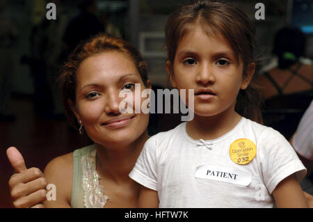 070719-N-7088A-005 PACIFIC OCEAN (July 19, 2007) - Lidia Farina and her daughter pose for a photo before being evaluated by Operation Smile medical personnel aboard Military Sealift Command hospital ship USNS Comfort (T-AH 20). Operation Smile, a non-government organization, joined the crew of the Comfort to perform cleft palette procedures while off the coast of Nicaragua. Comfort is on a four-month humanitarian deployment to Latin America and the Caribbean to provide medical treatment to patients in a dozen countries. While deployed, Comfort is under operational control of U.S. Naval Forces  Stock Photo