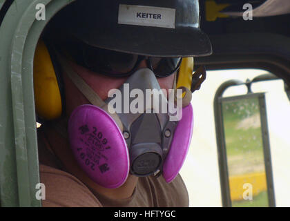 070831-N-3713P-001 CAMP COVINGTON, Guam (Aug. 31, 2007) - Equipment Operator Constructionman Apprentice Chance R. Keiter, attached to Naval Mobile Construction Battalion (NMCB) 4, wears a respirator while hauling rock from a recent blast at Orote Point Quarry to the rock crusher. NMCB-4 is deployed to Guam supporting construction requirements for Pacific Command. U.S. Navy photo by Mass Communication Specialist Seaman Tristan Miller (RELEASED) US Navy 070831-N-3713P-001 Equipment Operator Constructionman Apprentice Chance R. Keiter, attached to Naval Mobile Construction Battalion (NMCB) 4, wea Stock Photo