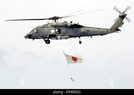 070917-N-5387K-052 SOUTH CHINA SEA (Sept. 17, 2007) - An SH-60 Seahawk, attached to the ÒChargersÓ of Helicopter Anti-Submarine Squadron (HS) 14, flies past USS Kitty Hawk (CV 63) with a Japanese flag during a practice air show. The practice air show was done in preparation for Kitty Hawk's upcoming friends and family day cruise. Kitty Hawk is more than three months into her summer deployment from Fleet Activities Yokosuka, Japan. U.S. Navy photo by Mass Communication Specialist 3rd Class Juan Antoine King (RELEASED) US Navy 070917-N-5387K-052 An SH-60 Seahawk, attached to the Chargers of Heli Stock Photo