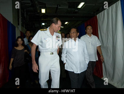 100906-N-6233H-042 PACIFIC OCEAN (Sept. 6, 2010) Rear Adm. Dan Cloyd, commander of Task Force 70, speaks with Jejomar Binay, vice president of the Republic of the Philippines, as he arrives for a reception aboard the aircraft carrier USS George Washington (CVN 73). Washington, the Navy's only permanently forward-deployed aircraft carrier, is visiting Manila Philippines to promote peace and stability in the Asia-Pacific region, demonstrating commitment to regional partners and foster growing relationships. (U.S. Navy photo by Mass Communication Specialist 3rd Class Rachel Hatch/Released) US Nav Stock Photo