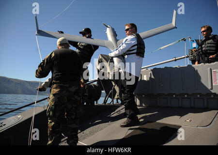 080207-N-5366K-286  SAN CLEMENTE ISLAND, Calif. (Feb. 7, 2008) Civilian contractors recover a Scan Eagle unmanned aerial vehicle launched from a MK V naval special warfare boat off the coast of San Clemente Island. This is the first time a Scan Eagle, used for various applications such as intelligence gathering and battle damage assessment, has been launched from this kind of platform. U.S. Navy photo by Mass Communication Specialist 3rd Class Michelle L. Kapica (Released) US Navy 080207-N-5366K-519 Civilian contractors recover a Scan Eagle unmanned aerial vehicle launched from a MK V naval sp Stock Photo