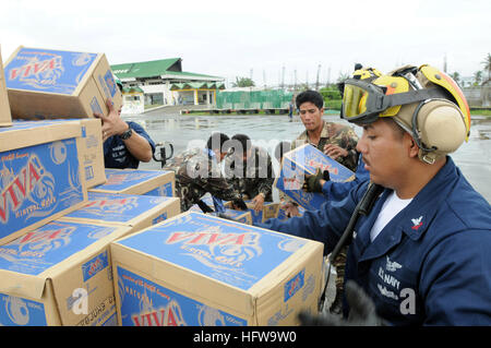 080629-N-5961C-014  KALIBO, Philippines (June 29, 2008) Aviation Boatswains Mate (Handler) 2nd Class William Sum unloads bottled water during relief efforts in wake of Typhoon Fengshen.  Petty Officer Sum, a native of Panorama City, Calif., is assigned to USS Ronald Reagan (CVN 76) and is ashore at the Kalibo Airport directing U.S. helicopters arriving with supplies. At the request of the government of the Republic of the Philippines, USS Ronald Reagan (CVN 76) and elements of her Carrier Strike Group (CSG) are off the coast of Panay Island providing humanitarian assistance and disaster respon Stock Photo