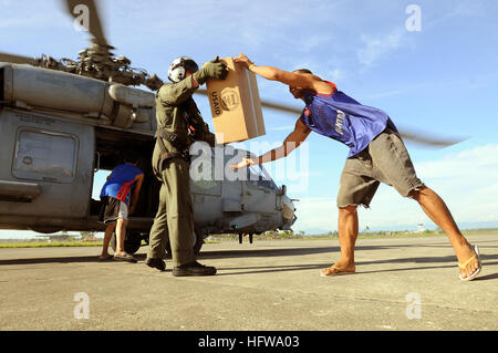 080701-N-5961C-007 KALIBO, Philippines (July 1, 2008) Aviation Warfare Systems Operator 2nd Class Slavek Glownia and a villager from Kalibo move a box of humanitarian supplies from an SH-60F Seahawk flown by members of Helicopter Anti-Submarine Squadron (HS) 4. Glownia and pilots and aircrew of HS-4 have been flying into Panay Island airlifting thousands of pounds of food and water in the wake of Typhoon Fengshen. The ÒBlack KnightsÓ are embarked aboard the aircraft carrier USS Ronald Reagan (CVN 76). U.S. Navy photo by Senior Chief Mass Communication Specialist Spike Call (Released) US Navy 0 Stock Photo