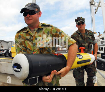 Navy and Australian personnel deploy a REMUS 100 autonomous underwater vehicle in Honolulu Harbor for coastal environmental measurements and mine warfare research. Stock Photo