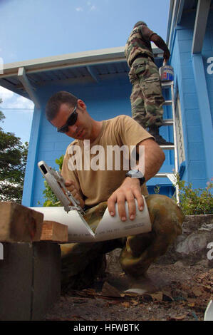 080810-N-7498L-131 PORT MORESBY, Papua New Guinea (Aug. 8, 2008) Australian Cpl. Mauricio Gonzalez, assigned to the Royal Australian Engineers, 1st Combat Engineer Regiment, cuts a PVC pipe for a water drainage system on a University of Papua New Guinea clinic building. U.S. Navy Seabees, Royal Australian engineers from 1st Combat Engineer Regiment and members of the Indian Army Corps of Engineers are providing humanitarian civic assistance to the people of Papua New Guinea as part of Pacific Partnership 2008. (U.S. Navy photo by Mass Communication Specialist 2nd Class Mark Logico/Released) US Stock Photo