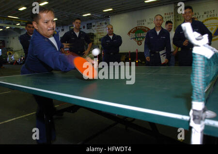 050623-N-9866B-023 Pacific Ocean (June 23, 2005) - Disbursing Clerk 1st Class Roel Edralin concentrates as he hits a ping-pong ball during a ship-wide competition in the hangar bay aboard the amphibious assault ship USS Peleliu (LHA 5). U.S. Navy photo by Journalist 2nd Class Zack Baddorf (RELEASED) US Navy 050623-N-9866B-023 Disbursing Clerk 1st Class Roel Edralin concentrates as he hits a ping-pong ball Stock Photo