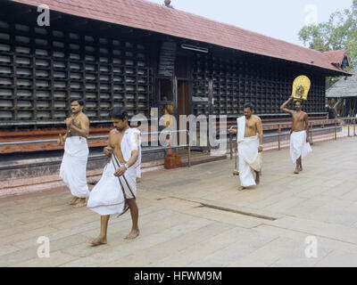 Holy people performing daily worship rituals in Shri Krishna temple, Ambalpuram, Kerala, India Stock Photo