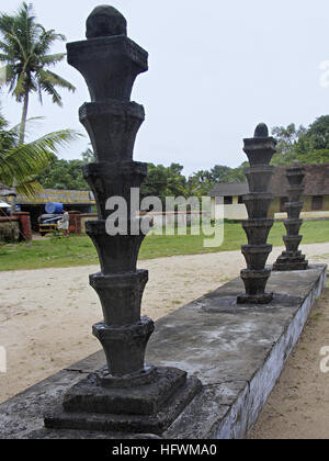 Pillar covered with oil lamps, Dharmashastra Temple, Tagari, Kerala, India Stock Photo