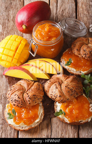 Scones with sweet mango jam and butter close-up on the table. vertical Stock Photo