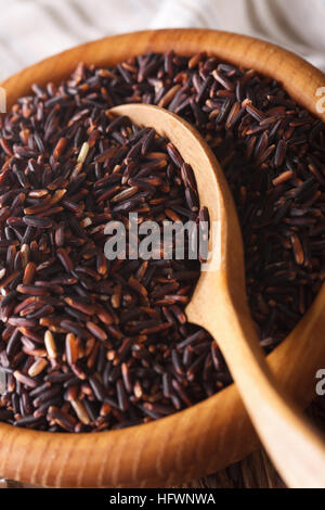 Raw wild black rice in a bowl macro. vertical background Stock Photo