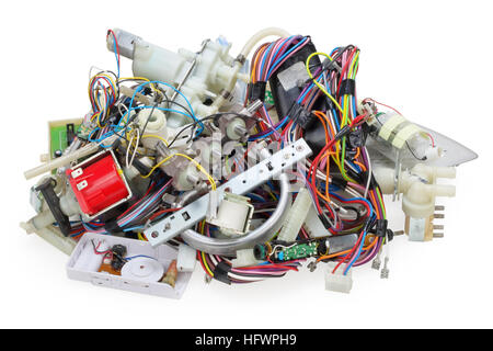 A huge lot of the old used and broken spare parts from electric devices lies on a table of a repair man.  Isolated on top studio shot Stock Photo