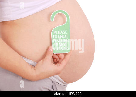 Do Not Disturb Baby Nursing sign in his hands pregnant woman on grey background Stock Photo