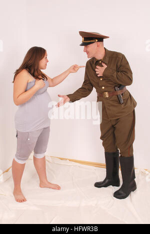 A joke. A pregnant woman and a man in uniform Stock Photo
