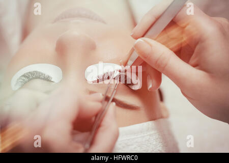 Eyelash Extension Procedure. Woman Eye with Long Eyelashes Stock Photo