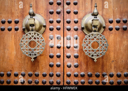 Elaborate door handles / knockers on studded wooden doors of the Kairaouine mosque in the medina of Fez, Morocco. Stock Photo