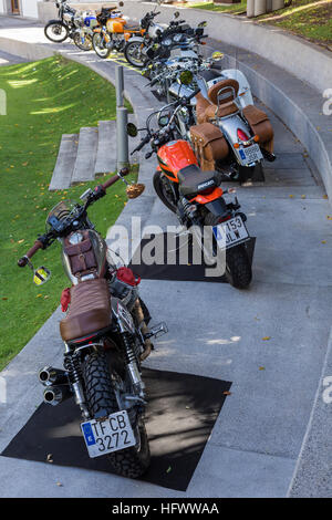 Row of motorcycles parked on a semi circular path Stock Photo