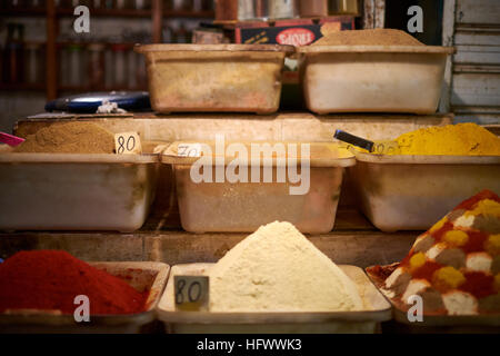 Pots of spices for sale in Meknes covered market. Powdered spices include cumin, turmeric and paprika. Stock Photo