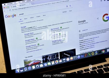 An Apple Macbook Pro displaying the Google web page Stock Photo