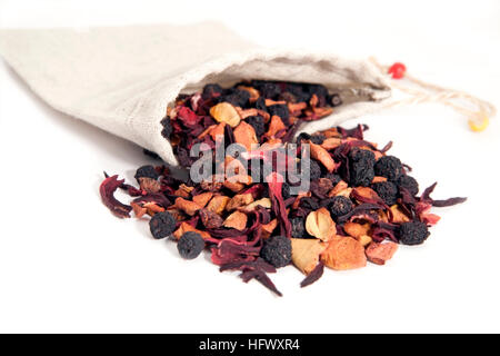 fruits and berries tea with hibiscus in linen bag over white Stock Photo