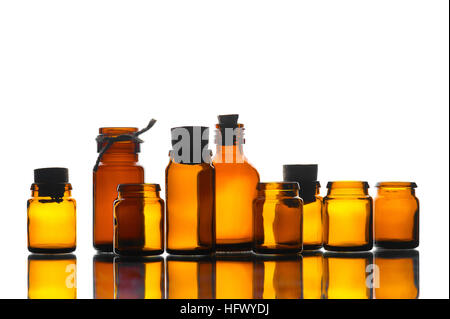 Various medicine yellow transparent bottles in the mirror table on the white background Stock Photo