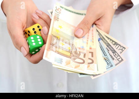 Taking a risk and winning concept with a pair of dice and different banknotes Stock Photo