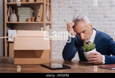 Troubled mature financer considering being fired Stock Photo
